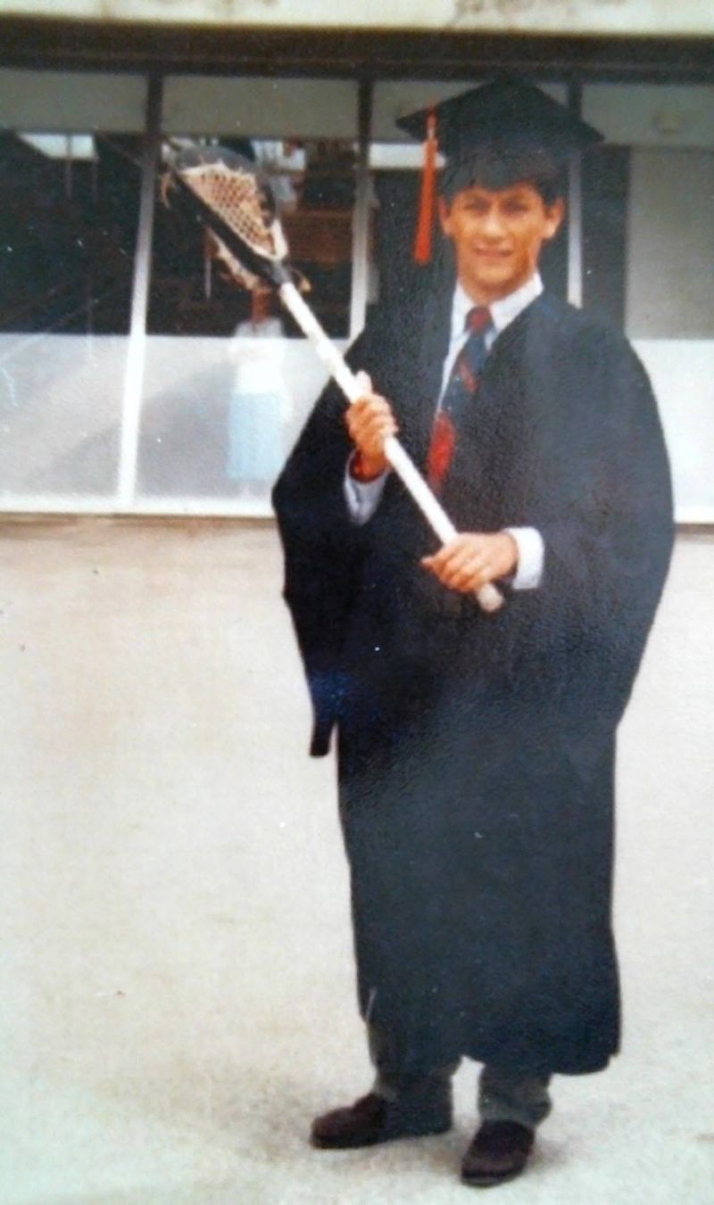 Steve in cap and gown at his 1992 Illinois graduation, holding a lacrosse stick